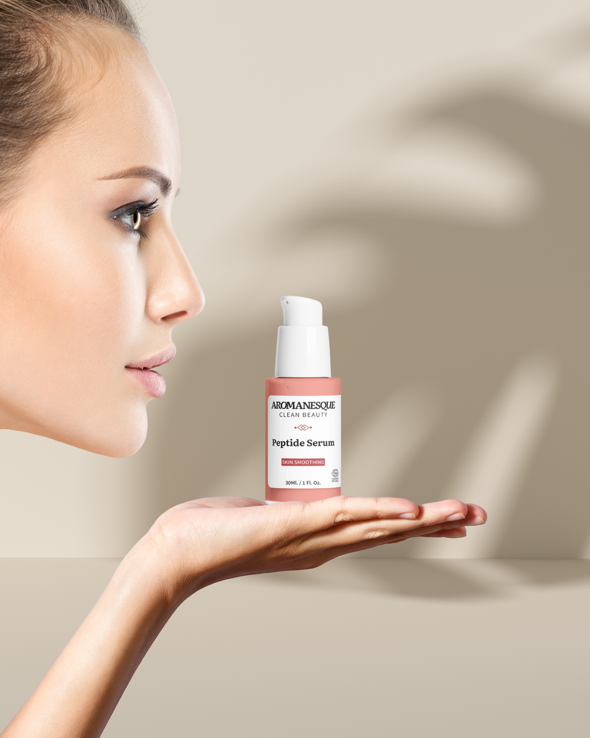 Woman holding a bottle of Bioelements Peptide Serum against a neutral background