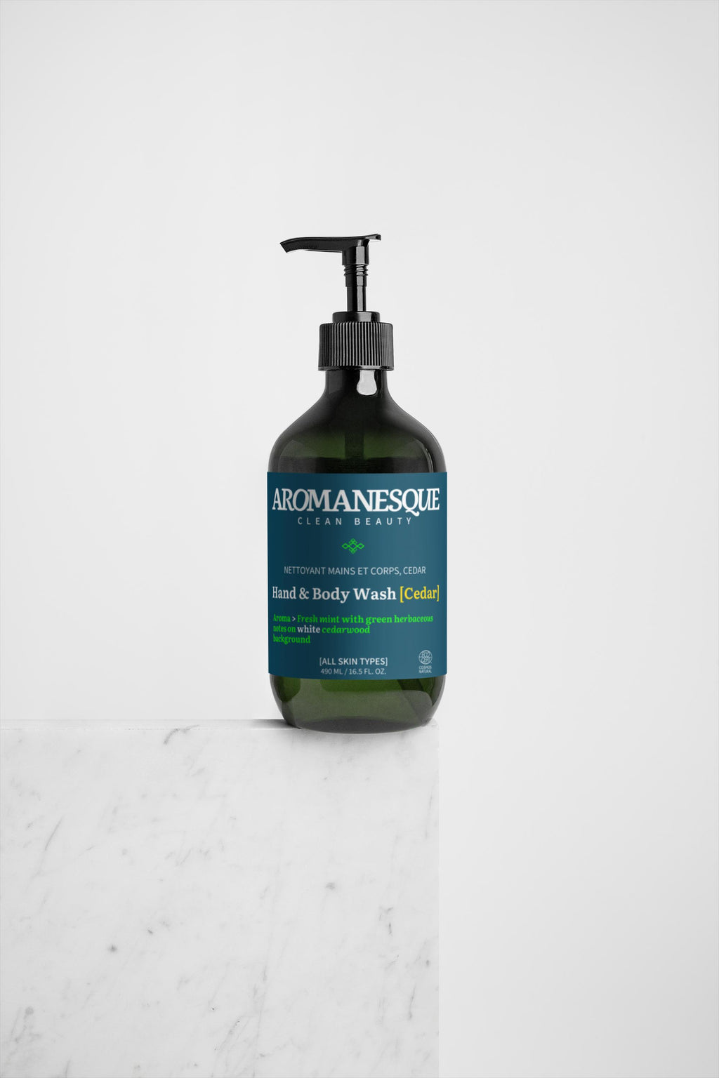 A pump bottle of Aromanesque Hand & Body Wash, Peppermint & Dark Cedar, against a white background.