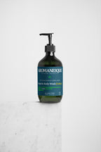 A pump bottle of Aromanesque Hand & Body Wash, Peppermint & Dark Cedar, against a white background.